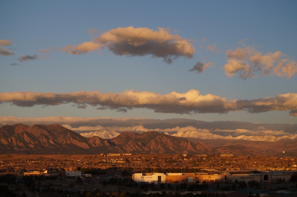 The Flatirons glowing at sunset, seen from Broomfield