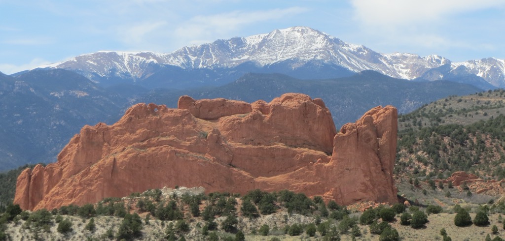 Snow-capped Pikes Peak rising behind the red rock formations of Garden of the Gods